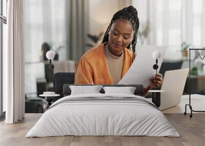 Black woman in home office, documents and laptop for research in remote work, ideas and thinking. Happy girl at desk with computer, writing notes and online search in house for freelance networking. Wall mural