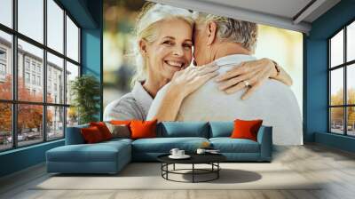 Hug, affection and portrait of a senior couple in nature for bonding, quality time and care in France. Smile, happy and face of an elderly woman hugging a man for romance in retirement in a park Wall mural