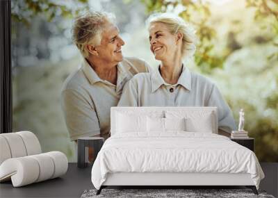 Love, hug or old couple in a park or nature bonding or holding hands in a happy marriage partnership. Retirement, senior man or romantic elderly woman hugging together in a relaxing holiday vacation Wall mural