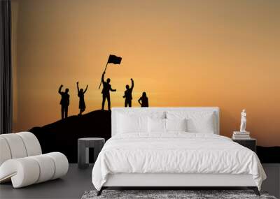 Silhouette of people are celebrating success at the top of the mountain, sky and sun light background. Team business concept. Wall mural