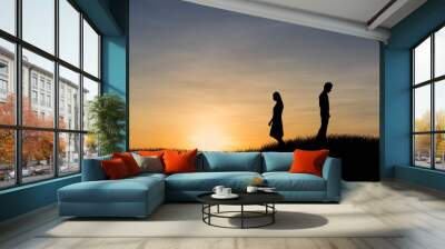 Silhouettes of couple man and woman broken heart at nature sunset. Love concept. Wall mural