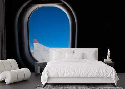 aircraft window with blue sky. Wall mural