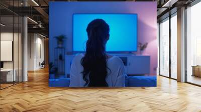 Digital mockup caucasian woman in her 20s in front of an smart-tv with an entirely blue screen Wall mural