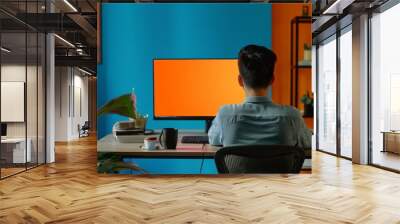 Display mockup asian man in his 20s in front of a computer with a fully orange screen Wall mural