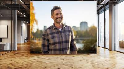 Portrait of a blissful man in his 40s wearing a comfy flannel shirt against a vibrant city park. AI Generation Wall mural