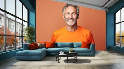 Portrait of a cheerful man in his 50s sporting a breathable mesh jersey against a solid color backdrop. AI Generation Wall mural