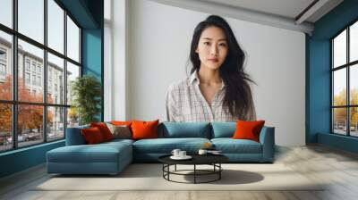 Portrait of a glad asian woman in her 20s dressed in a relaxed flannel shirt against a modern minimalist interior. AI Generation Wall mural