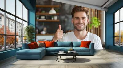 Portrait of a grinning man in his 30s showing a thumb up over modern minimalist interior Wall mural