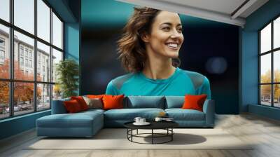 portrait of a grinning woman in her 30s sporting a breathable mesh jersey against a soft teal backgr Wall mural