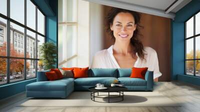 Portrait of a happy woman in her 40s wearing a simple cotton shirt against a serene meditation room. AI Generation Wall mural