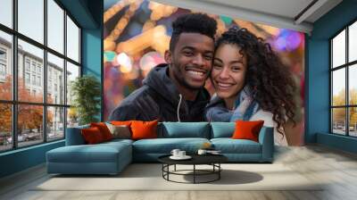 Portrait of a jovial multicultural couple in their 20s wearing a thermal fleece pullover in front of lively amusement park background Wall mural