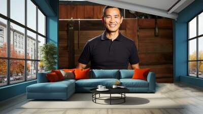 portrait of a merry asian man in his 40s wearing a sporty polo shirt against a rustic wooden wall. a Wall mural