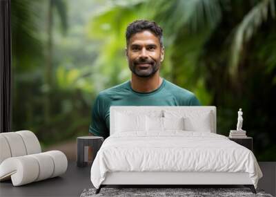 Portrait of a smiling indian man in his 40s wearing a moisture-wicking running shirt against a lush tropical rainforest. AI Generation Wall mural