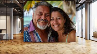 Portrait of a smiling middle aged Hispanic couple at the beach Wall mural