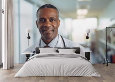 Portrait of a smiling middle aged male doctor in hospital Wall mural