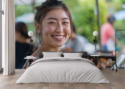 Portrait of a smiling young woman attending a barbecue Wall mural