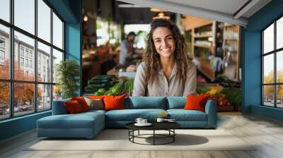 Smiling young woman working in a healthy food store Wall mural