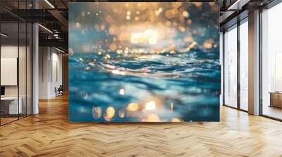 A serene image of sunlit water with a sparkling effect, mixing blue and golden hues. Green plants frame the scene, with varying light intensities adding warmth. Wall mural