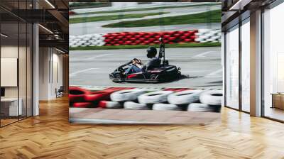 man drive go kart on track Wall mural