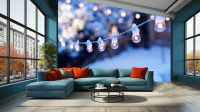 Christmas party lights in a winter garden Wall mural