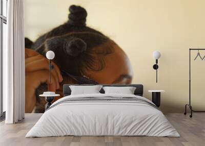 Teenager laying hair edges Wall mural