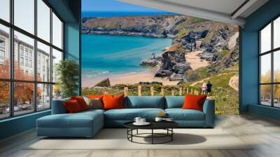 Bedruthan Steps, Cornwall, UK - The famous sea stacks, with pathway and couple in hats looking at view. Wall mural