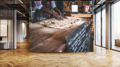 African man making bread with raw dough Wall mural