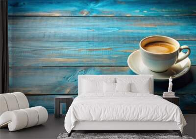 Coffee cup sitting on a rustic blue wooden background Wall mural