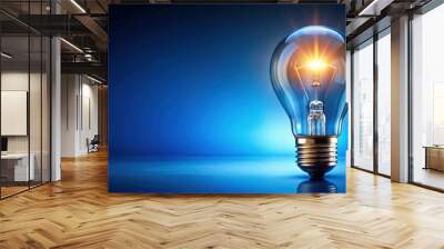 Glowing light bulb on blue background symbolizing creativity and ideas, innovation, inspiration, brainstorming Wall mural