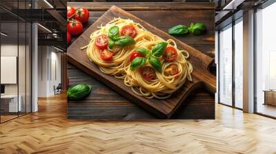 Italian style pasta dinner with spaghetti, tomato, basil, and ingredients on wooden board over dark plywood background Wall mural