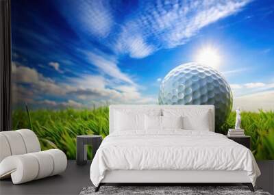 of a golf ball on green grass under a blue sky Wall mural