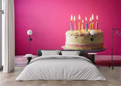 Pink background birthday cake with candles spelling happy birthday in pink and gold Wall mural