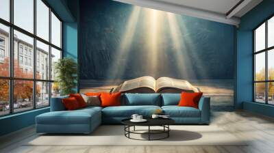 Stock photo of a bible open in a dark room with light pouring out, representing enlightenment Wall mural