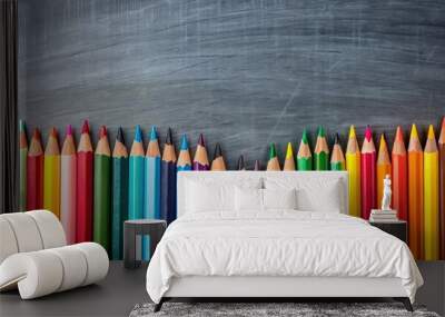 Top view of colored pencils on chalkboard background with copy space for art education concept Wall mural