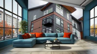 Low angle view of a modern style apartment building, with lots of windows on a sunny, cloudy day Wall mural