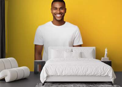 Attractive African American man wearing blank white t-shirt on yellow background. Mockup for tshirt print design Wall mural