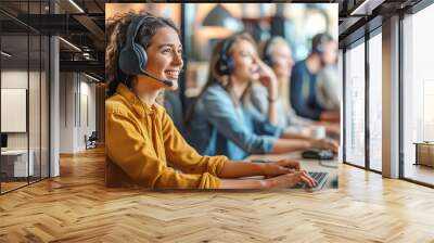 Attractive female customer service agent with headset working in call center Wall mural