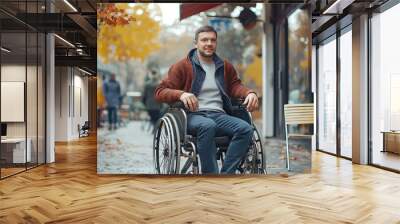 Autumn stroll: disabled man in wheelchair enjoying a day outdoors with vibrant fall foliage Wall mural