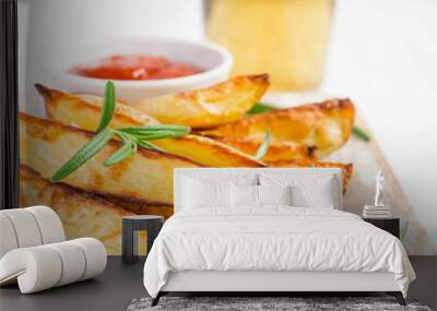 Baked fried potatoes with rosemary and tomato sauce on a white background, selective focus Wall mural