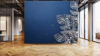 Christmas blue background. Shining silver pattern made of frost decorative leaves Wall mural