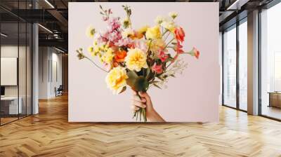 Female hand holds beautiful colorful bouquet Wall mural