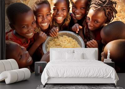 Group of African children eat meager food with their hands from a large metal plate Wall mural