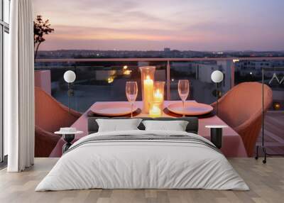 Roof terrace with festive table setting for romantic dinner by candlelight with city view. Decorations for Valentine's Day, Engagement, Date Wall mural