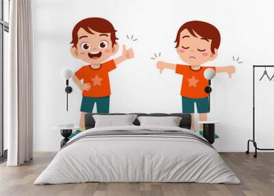 little boy show hand gesture thumb up and thumb down Wall mural