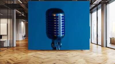 Retro microphone against dim blue light restaurant background. Wall mural