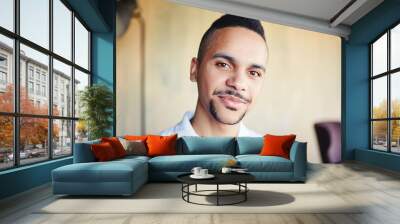 Portrait of handsome mixed race young man looking at camera feeling confident Wall mural