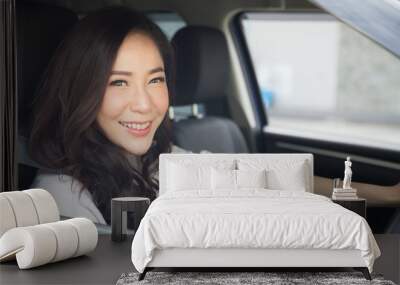 Asian women driving a car and smile happily with glad positive expression during the drive to travel journey, People enjoy laughing transport and relaxed happy woman on roadtrip vacation concept Wall mural