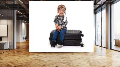 Happy kid Asian boy smiling and sitting on a black suitcase isolated over white background, Airplane travel concept, Two year one month old Wall mural