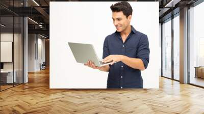 Portrait of an excited man holding laptop computer and celebrating success over white background, Raising arms with a look of happiness, Male model Wall mural