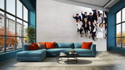 Top view of group of multiethnic business people celebrating and .happy success positive teamwork with hands up. Victory successful, celebrate achievement and acquisitions concept. Aerial view. Wall mural